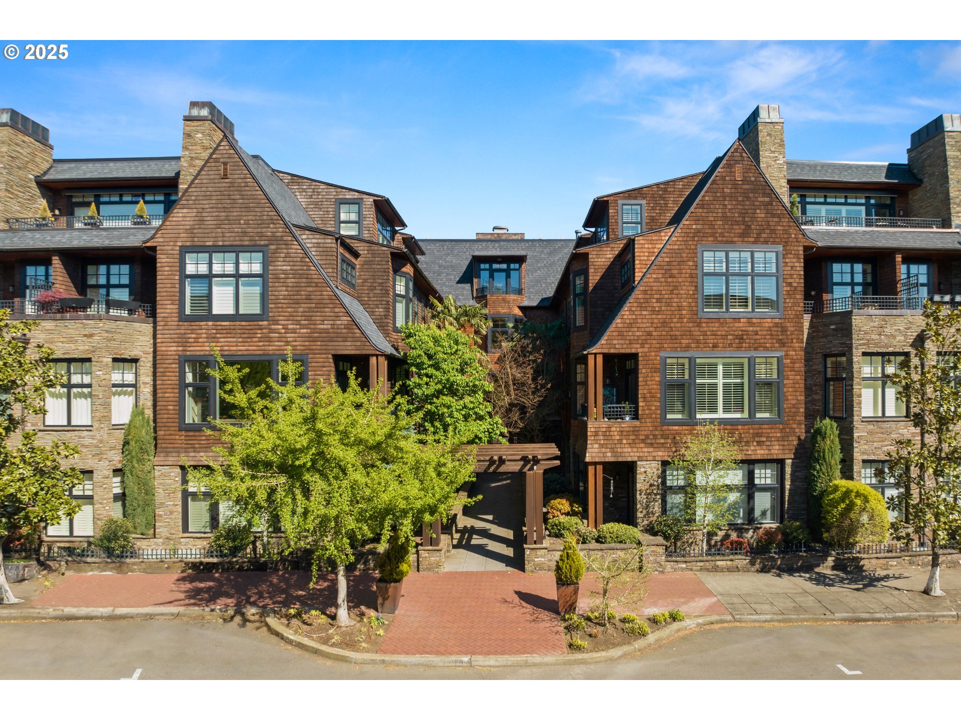 a front view of a residential apartment building with a yard
