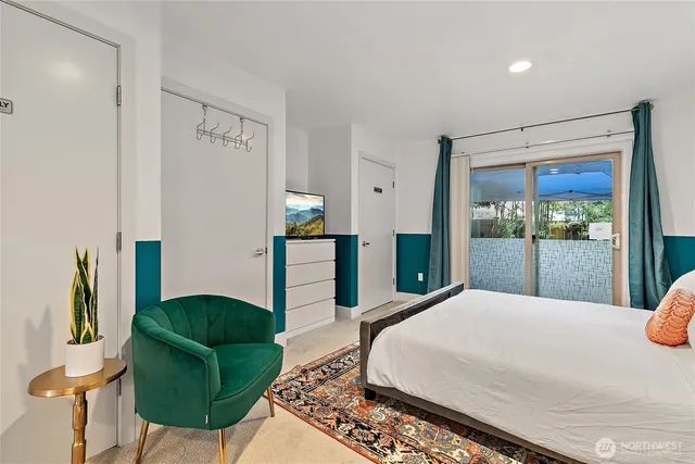 a bed sitting in a spacious bedroom next to a window