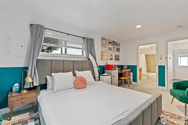 a bedroom with a bed and a table