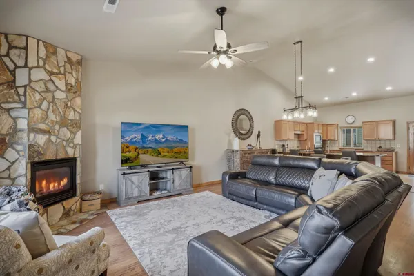 a living room with furniture a fireplace and a chandelier