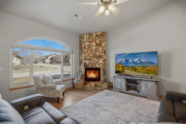 a living room with furniture a fireplace and a flat screen tv