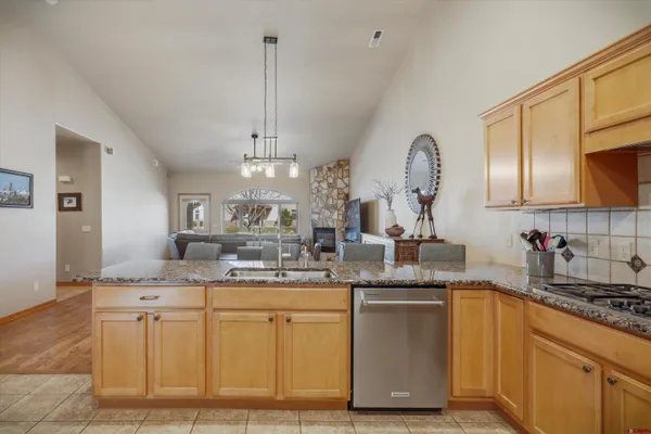 a kitchen with stainless steel appliances granite countertop a sink and stove top oven