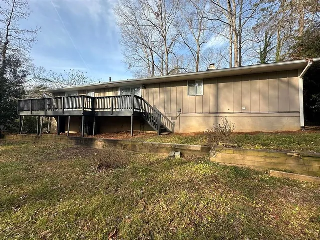 a view of a field with trees in the background