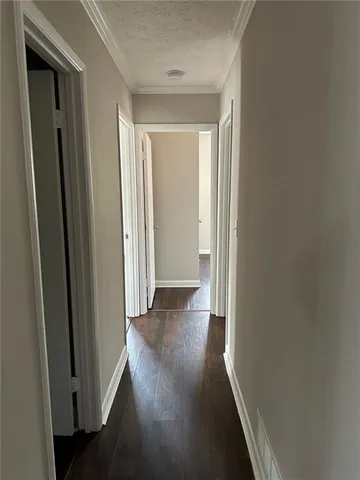 a view of a hallway with wooden floor