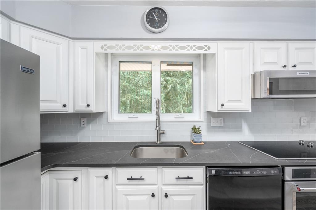 424 Brooks Road Wexford, PA 15090 - Photo 14 of 46 a kitchen with stainless steel appliances granite countertop a sink a stove and a granite counter tops with white cabinets