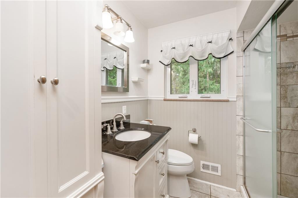 424 Brooks Road Wexford, PA 15090 - Photo 15 of 46 a bathroom with a sink a mirror and a toilet