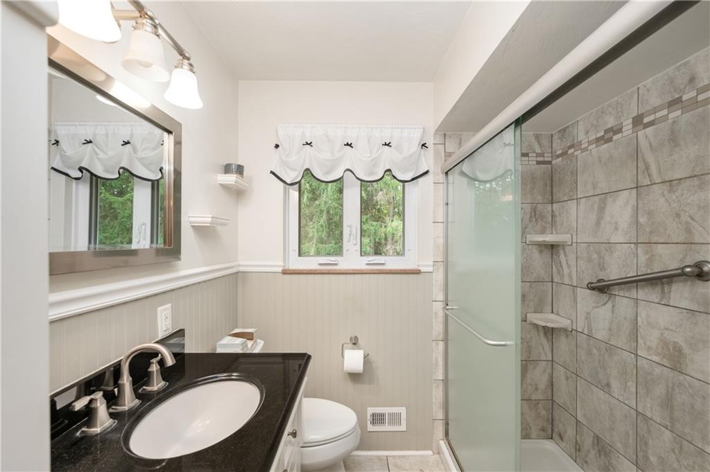 424 Brooks Road Wexford, PA 15090 - Photo 16 of 46 a bathroom with a granite countertop sink vanity mirror bathtub and toilet