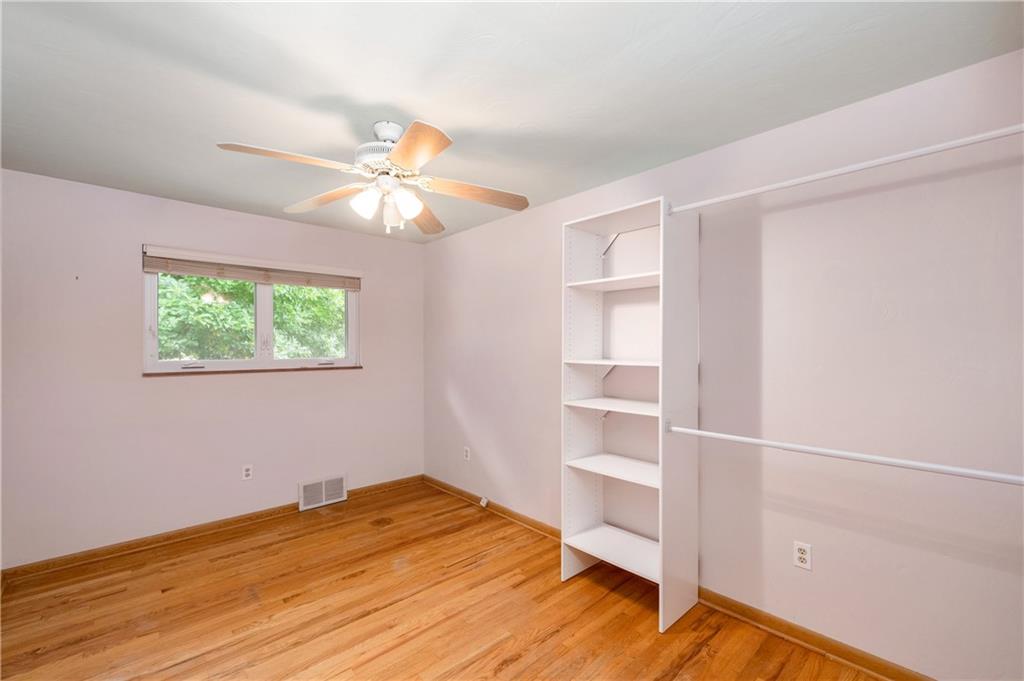 424 Brooks Road Wexford, PA 15090 - Photo 17 of 46 a view of a room with wooden floor and a ceiling fan