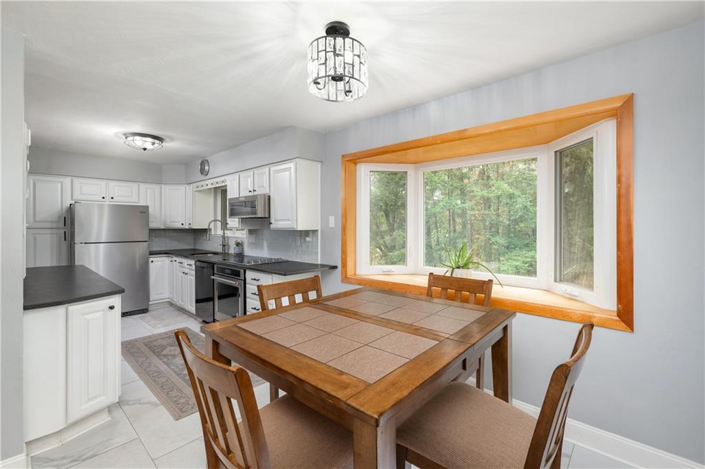 424 Brooks Road Wexford, PA 15090 - Photo 9 of 46 a kitchen with a table chairs refrigerator and window
