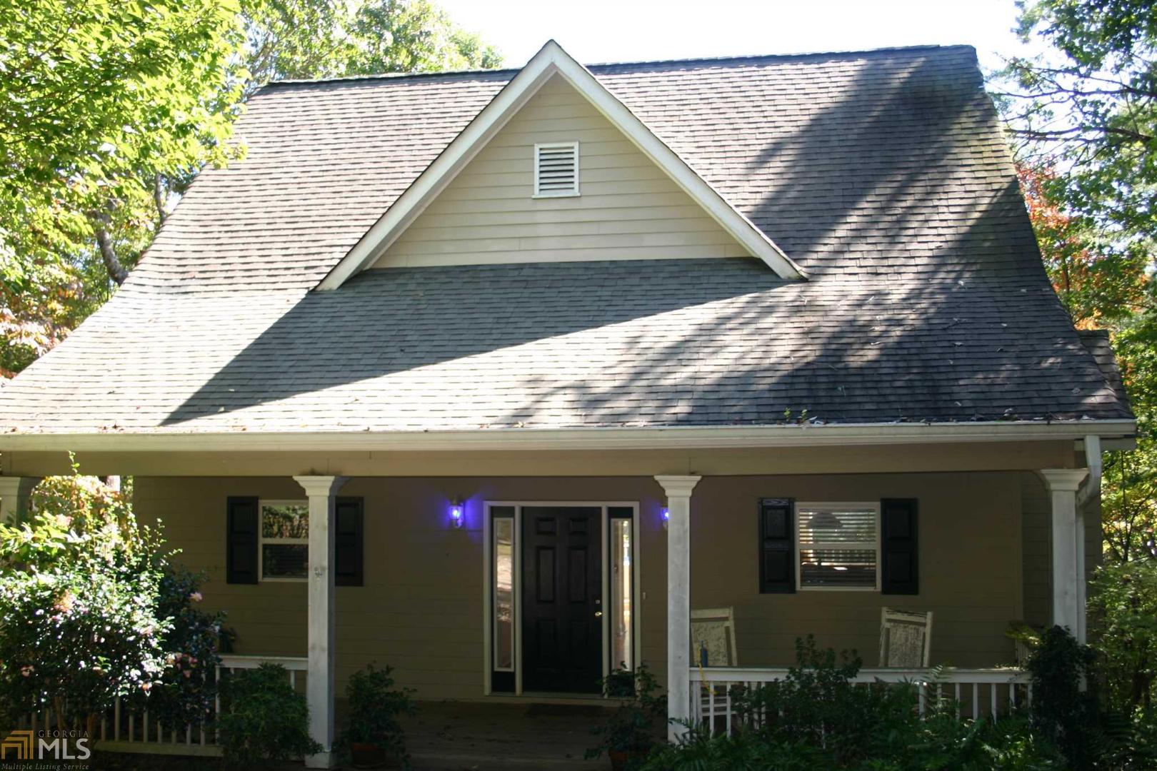 a front view of a house with plants