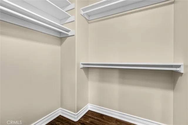 a view of a closet with wooden floor