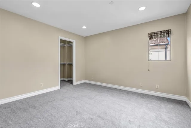 an empty room with closet and a window