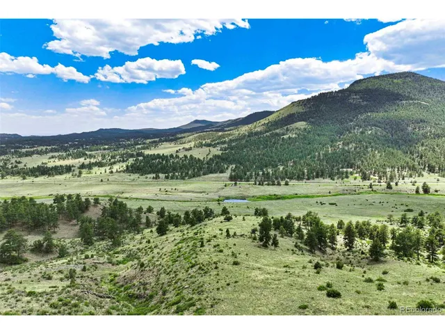 a view of a town with mountains in the background