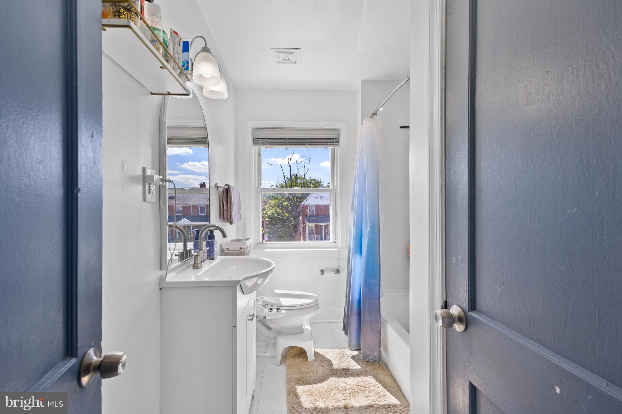 4511 Marble Hall Road Baltimore, MD 21239 - Photo 25 of 48 a bathroom with a sink toilet and shower a mirror