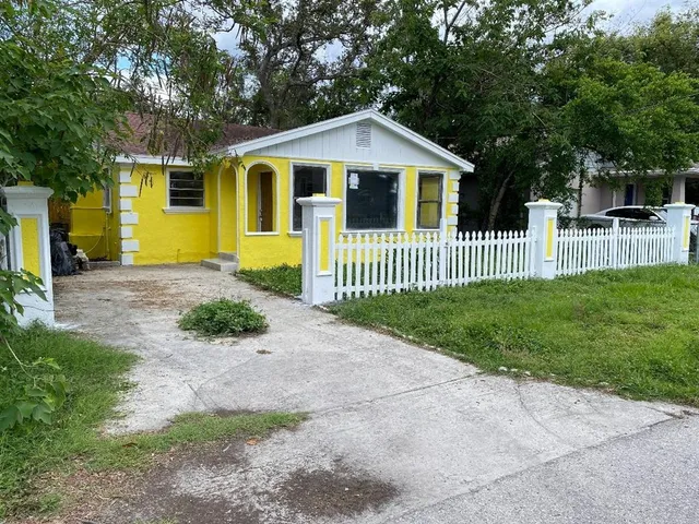 a front view of a house with a yard table and chairs