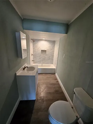 a bathroom with a sink toilet and mirror