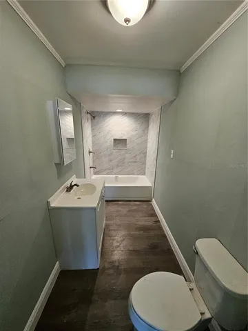a bathroom with a sink mirror vanity and toilet