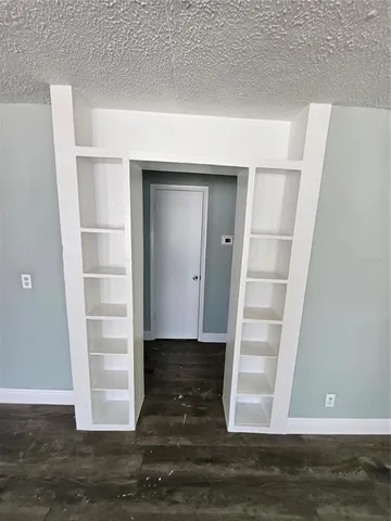 a view of walk in closet with empty racks