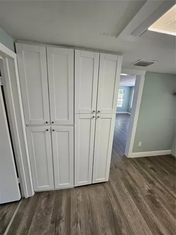 a view of a hallway with wooden floor