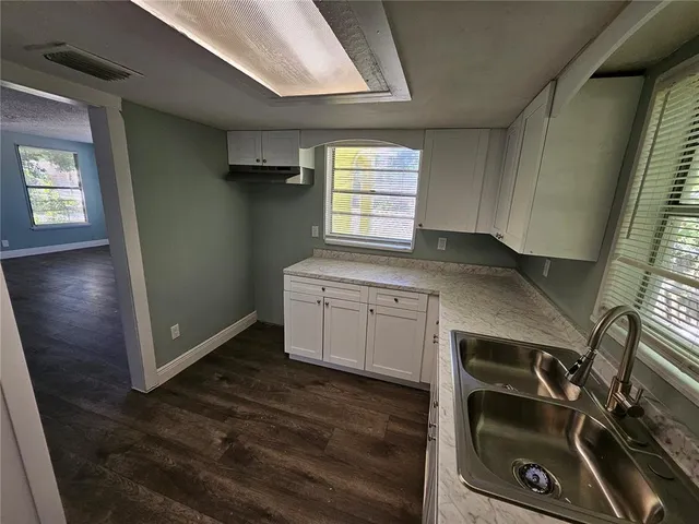 a kitchen with a sink and a stove top oven