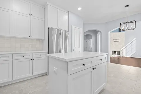 a view of a kitchen with white cabinets