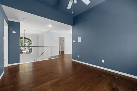 a view of a livingroom with wooden floor and a window