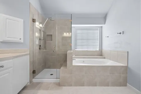 a bathroom with a tub shower and sink