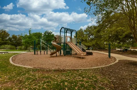 a view of a park with swings and slides