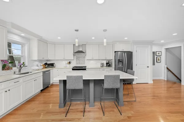a kitchen with stainless steel appliances kitchen island granite countertop a sink and cabinets