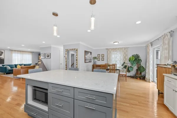 a view of kitchen with sink and refrigerator