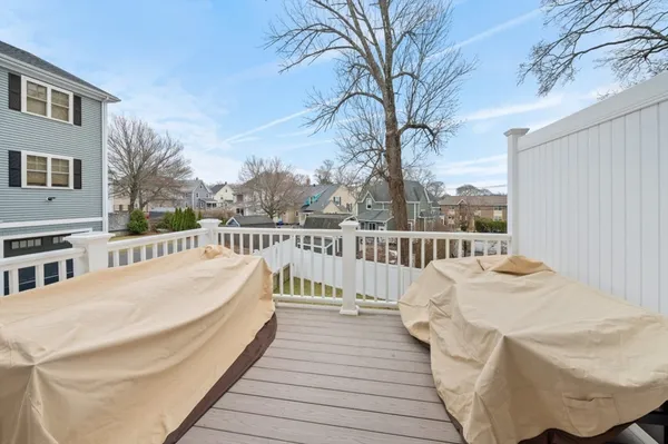 a view of balcony with wooden floor and fence
