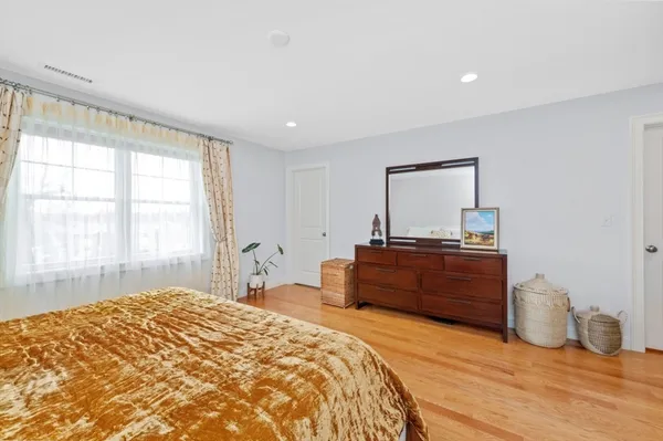 a bedroom with a bed and two windows