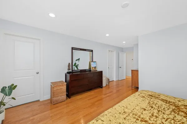 a bedroom with a bed and a dresser