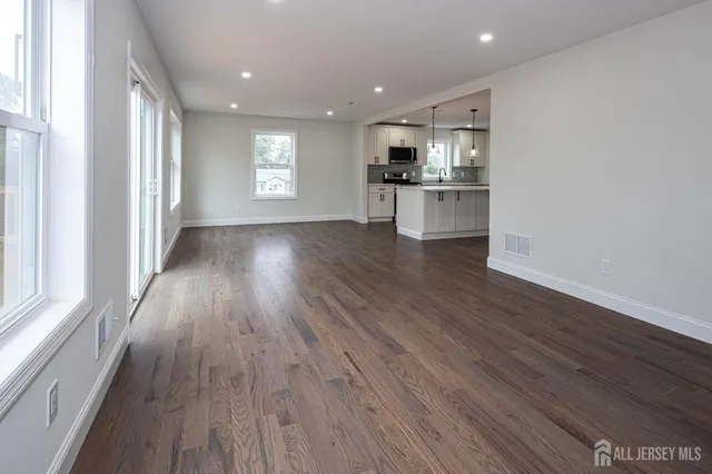 a view of kitchen with wooden floor and electronic appliances
