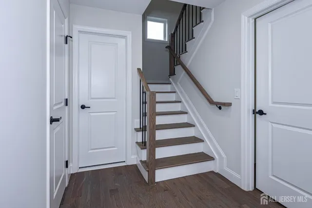 a view of entryway with wooden floor and stairs