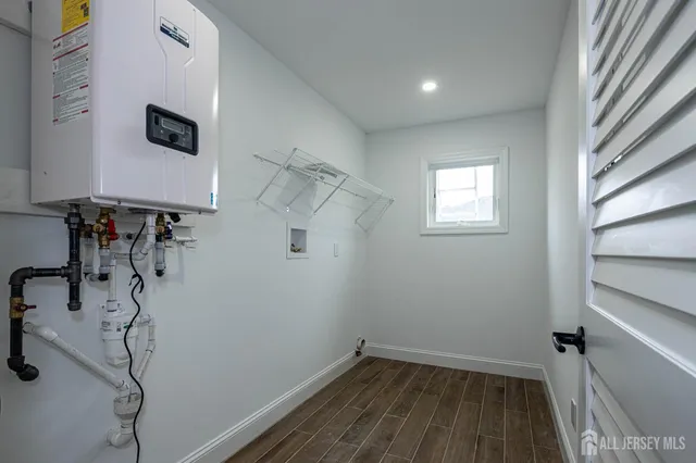a view of a room with wooden floor and windows