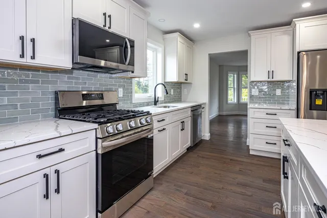 a kitchen with stainless steel appliances a stove microwave and cabinets