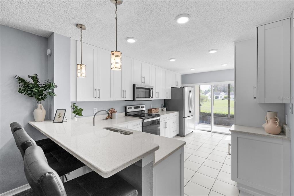 4515 Whitton Way, Unit 117 New Port Richey, FL 34653 - Photo 12 of 35 a kitchen with counter space cabinets and appliances