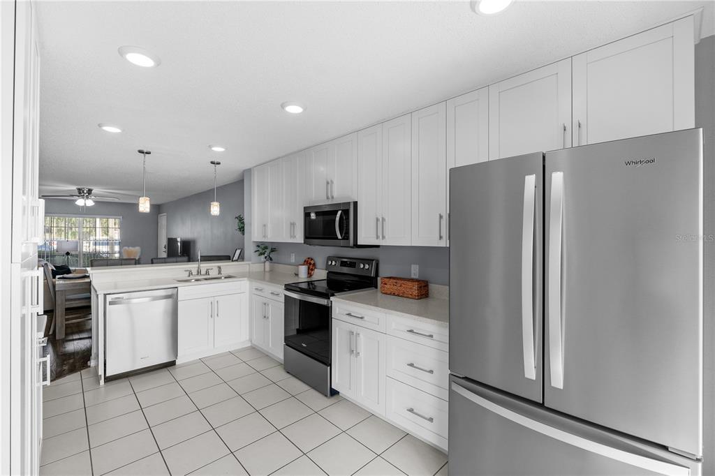 4515 Whitton Way, Unit 117 New Port Richey, FL 34653 - Photo 15 of 35 a kitchen with granite countertop appliances cabinets and a sink