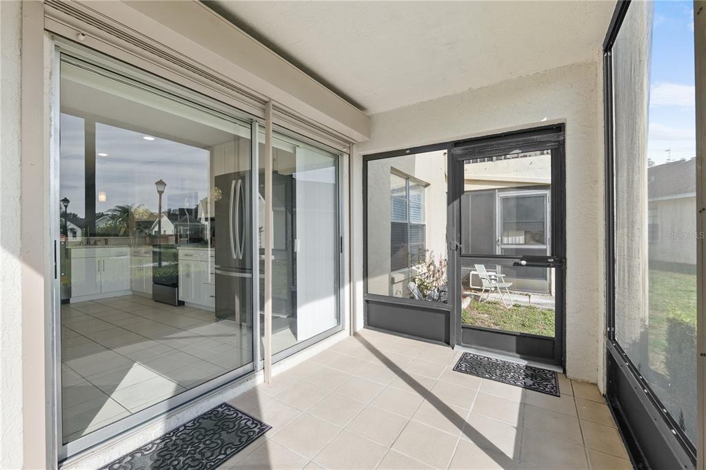 4515 Whitton Way, Unit 117 New Port Richey, FL 34653 - Photo 23 of 35 a room with large glass windows and a table