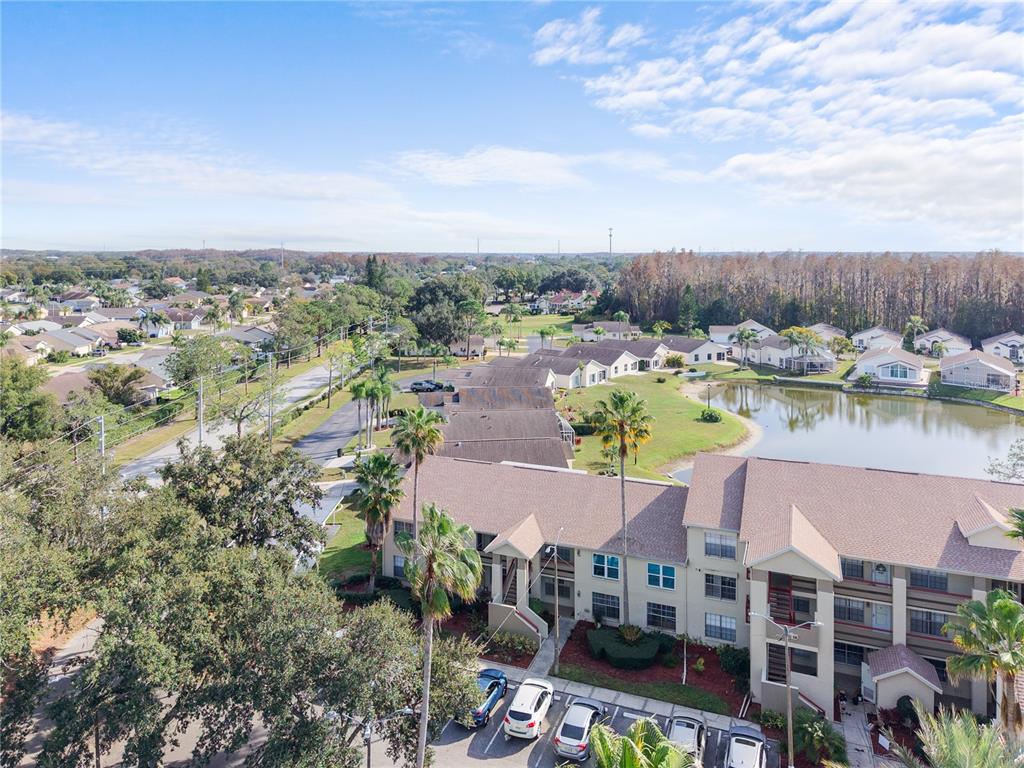 4515 Whitton Way, Unit 117 New Port Richey, FL 34653 - Photo 27 of 35 a view of a lake with building in front of it