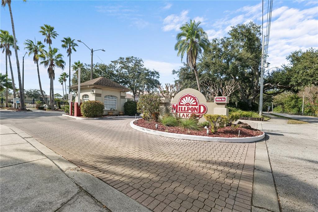 4515 Whitton Way, Unit 117 New Port Richey, FL 34653 - Photo 3 of 35 a sign board with flower plants and wooden fence