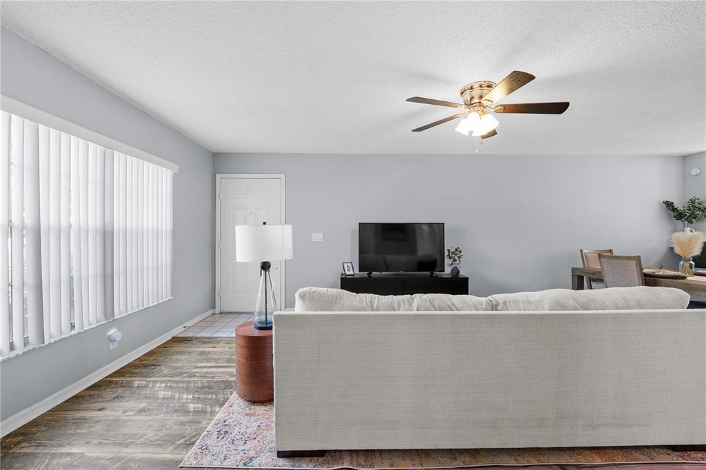 4515 Whitton Way, Unit 117 New Port Richey, FL 34653 - Photo 6 of 35 a living room with furniture and a flat screen tv