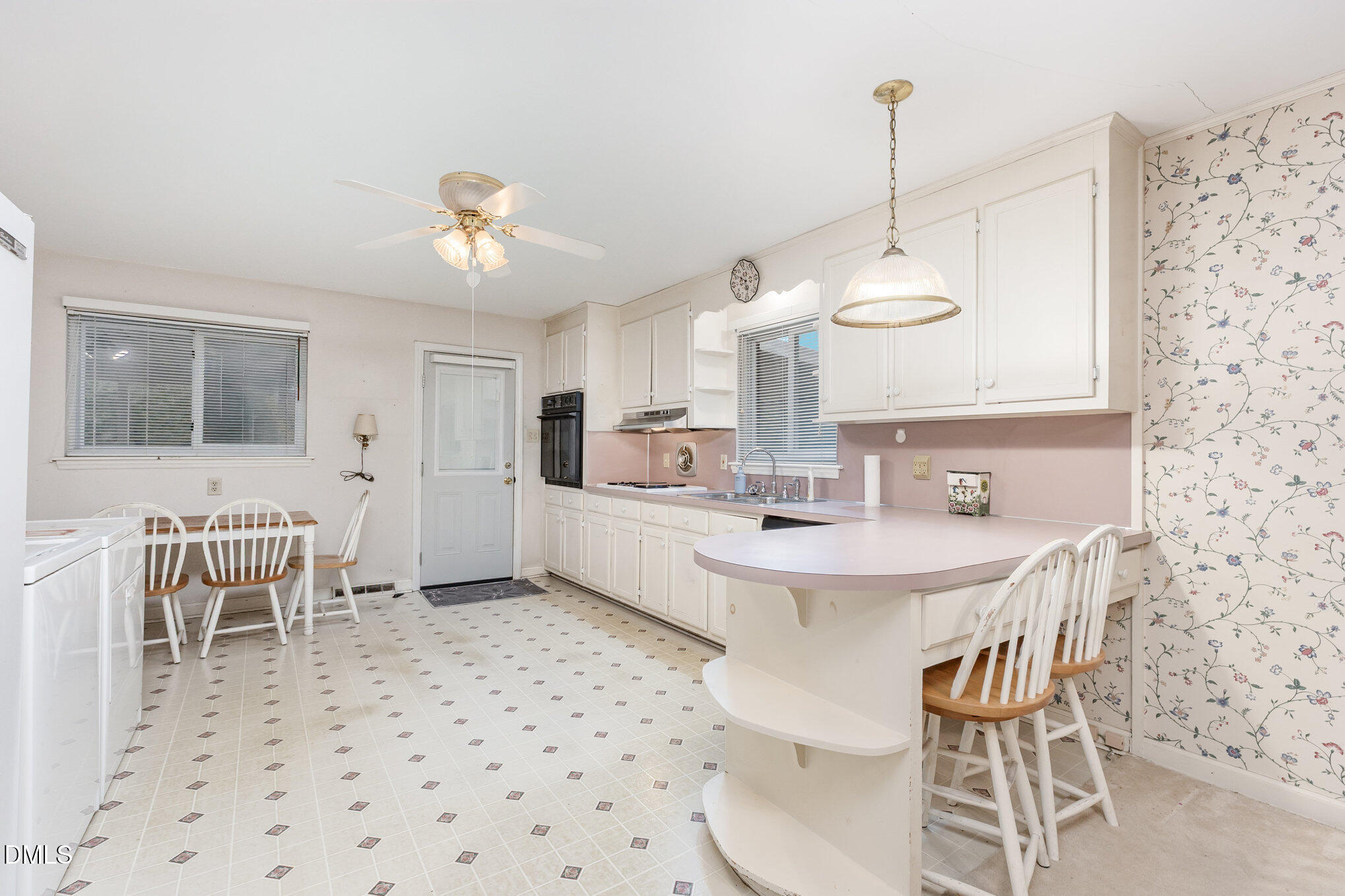 615 Horton Road Durham, NC 27704 - Photo 4 of 19 a kitchen with a dining table chairs sink and cabinets