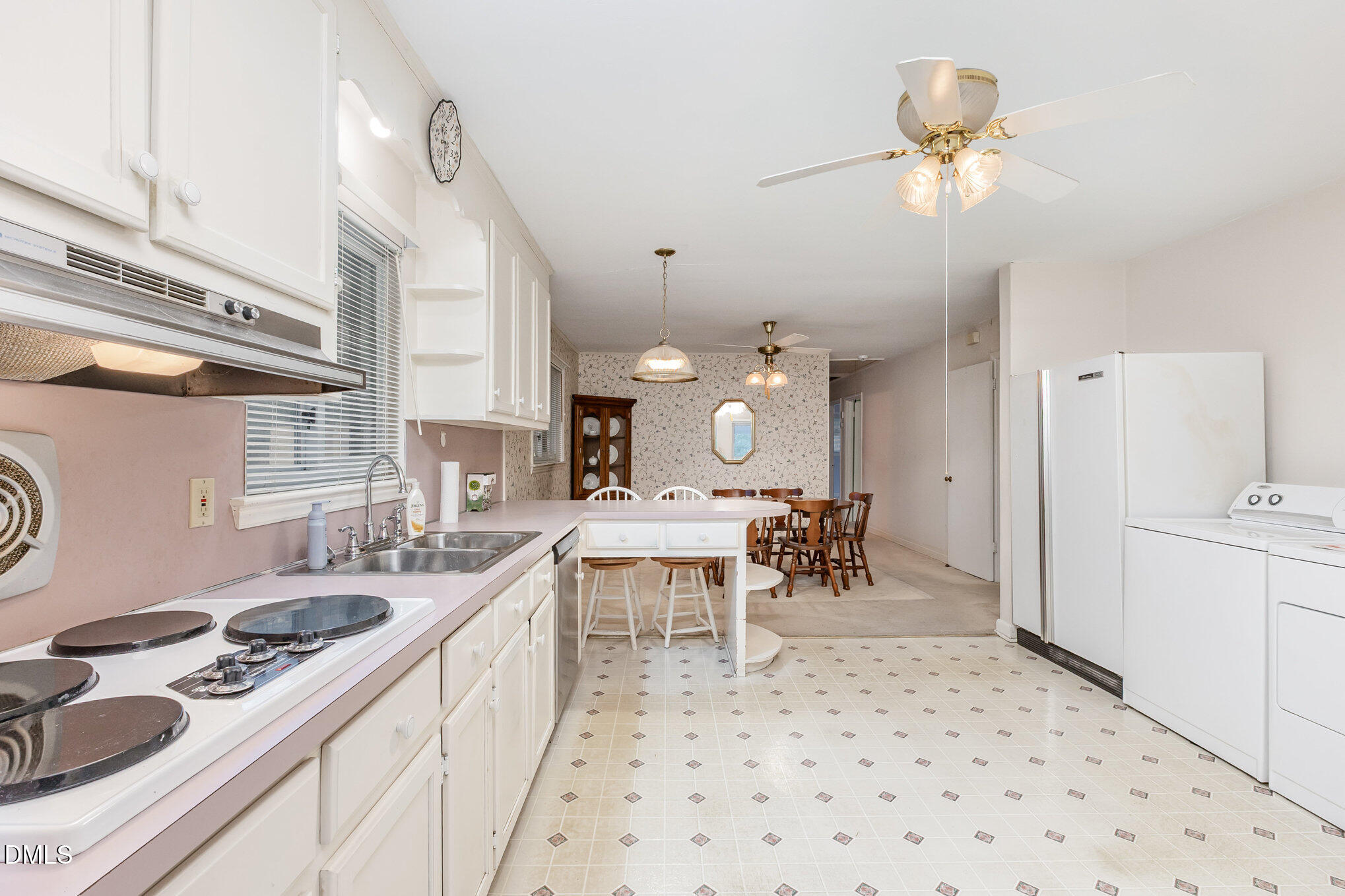 615 Horton Road Durham, NC 27704 - Photo 5 of 19 a large white kitchen with a white stove a dining table and chairs