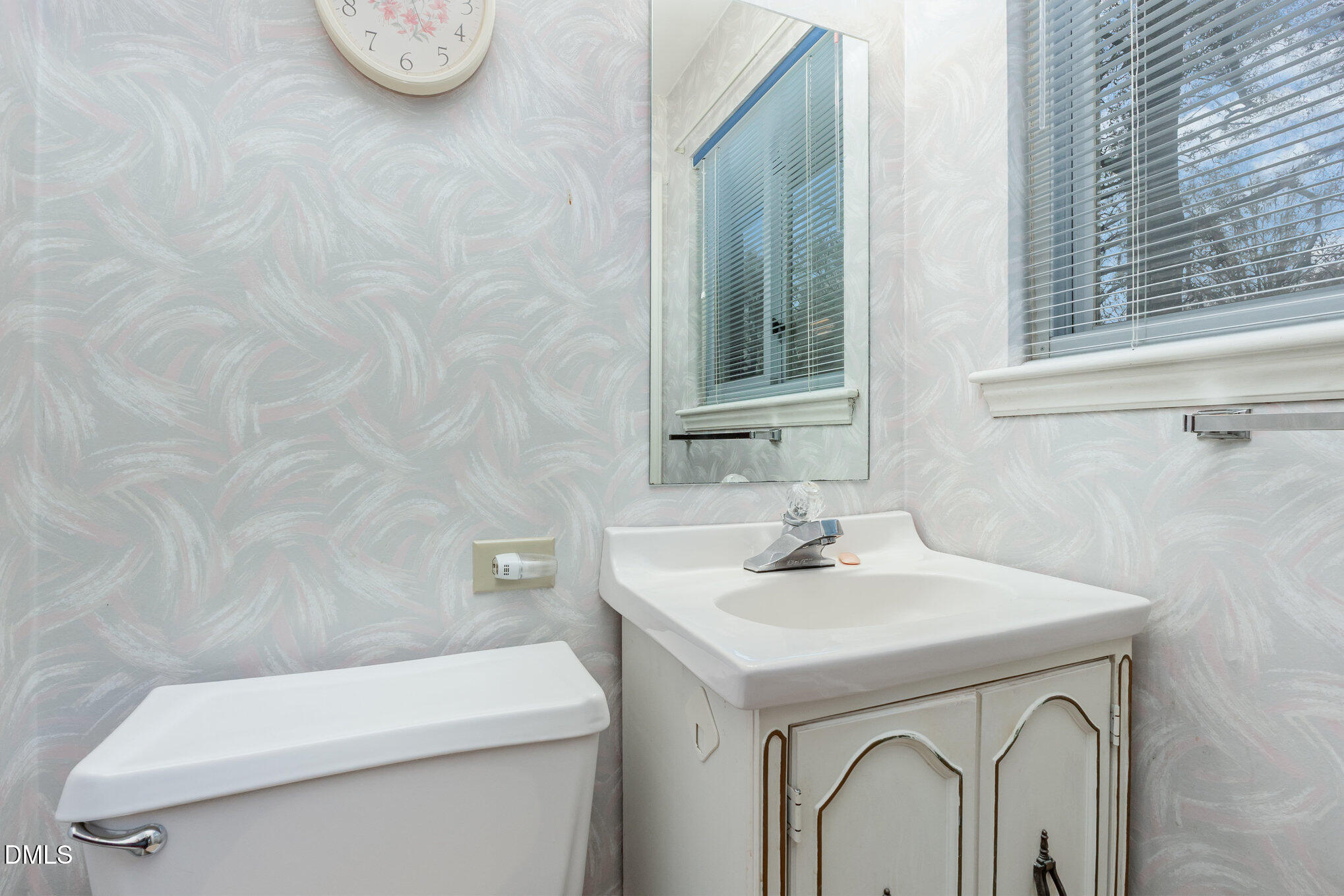 615 Horton Road Durham, NC 27704 - Photo 9 of 19 a bathroom with a sink a toilet and a mirror