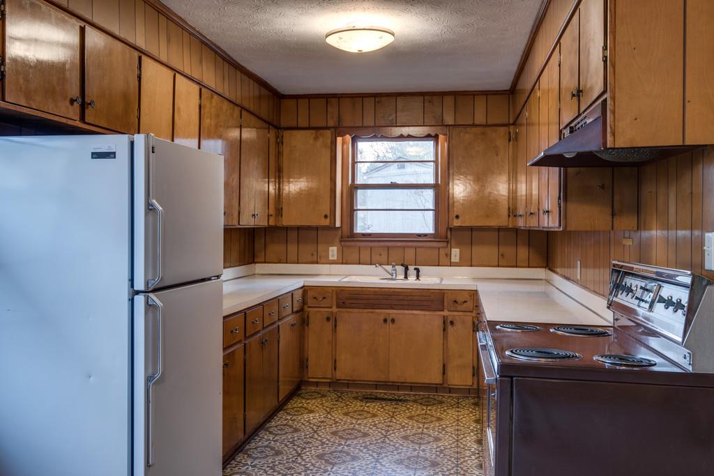 103 Cardinal Road Dickson, TN 37055 - Photo 9 of 24 a kitchen with a sink a refrigerator and cabinets
