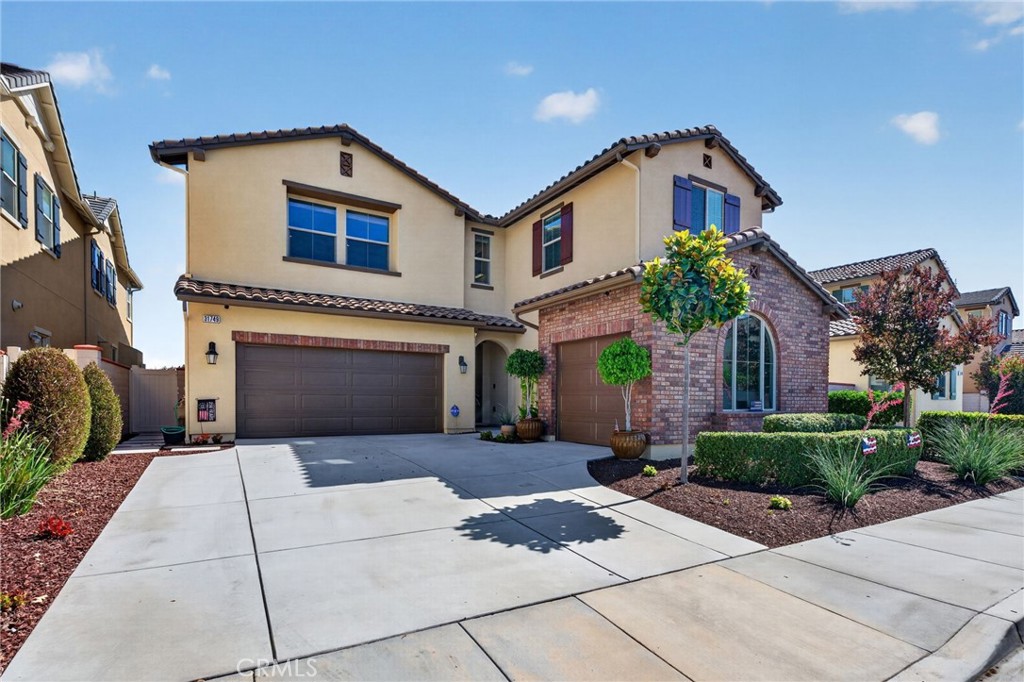 31749 Country View Road Temecula, CA 92591 - Photo 4 of 68 a front view of a house with a garden