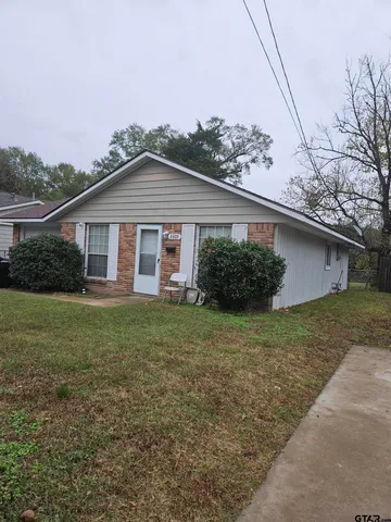 a view of a house with yard and a garden