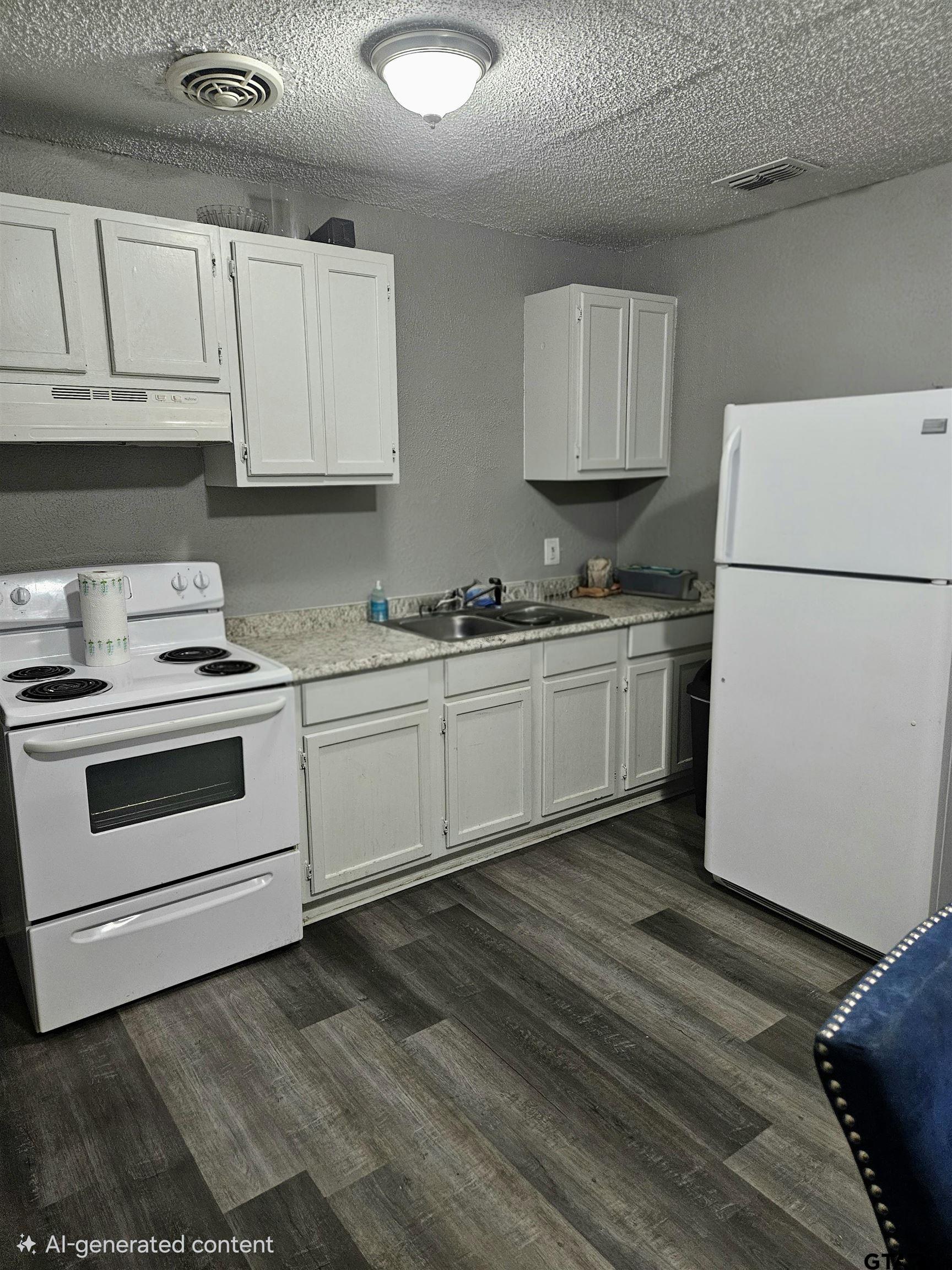 3309 North Luberta Street Tyler, TX 75702 - Photo 5 of 14 a kitchen with white cabinets and white appliances